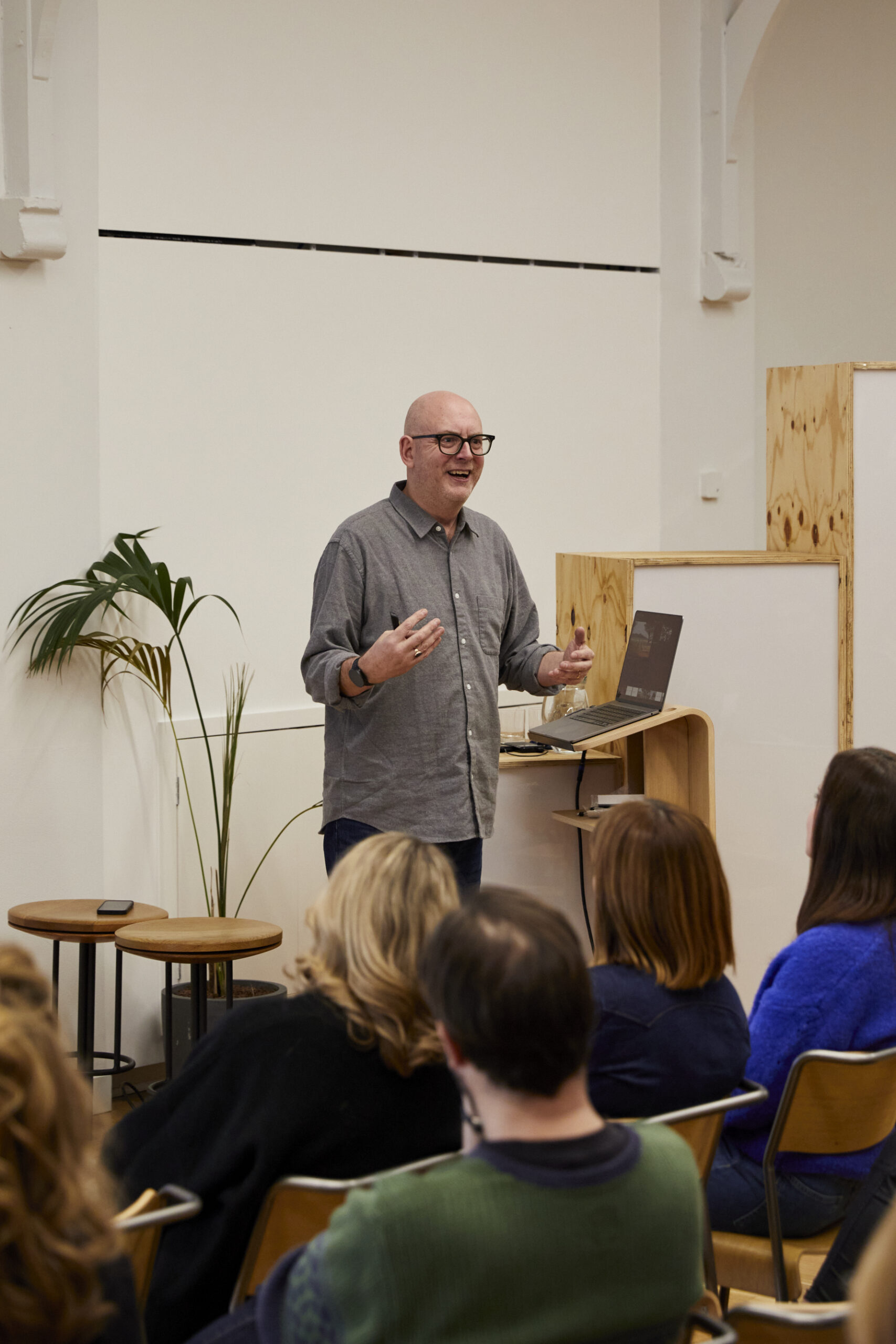 A man in a shirt is giving a presentation